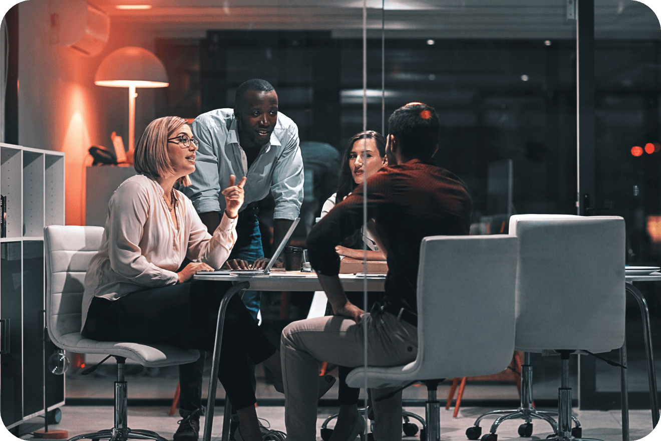 Colleagues around a table reviewing metrics and deep inventory insights across the programmatic stack